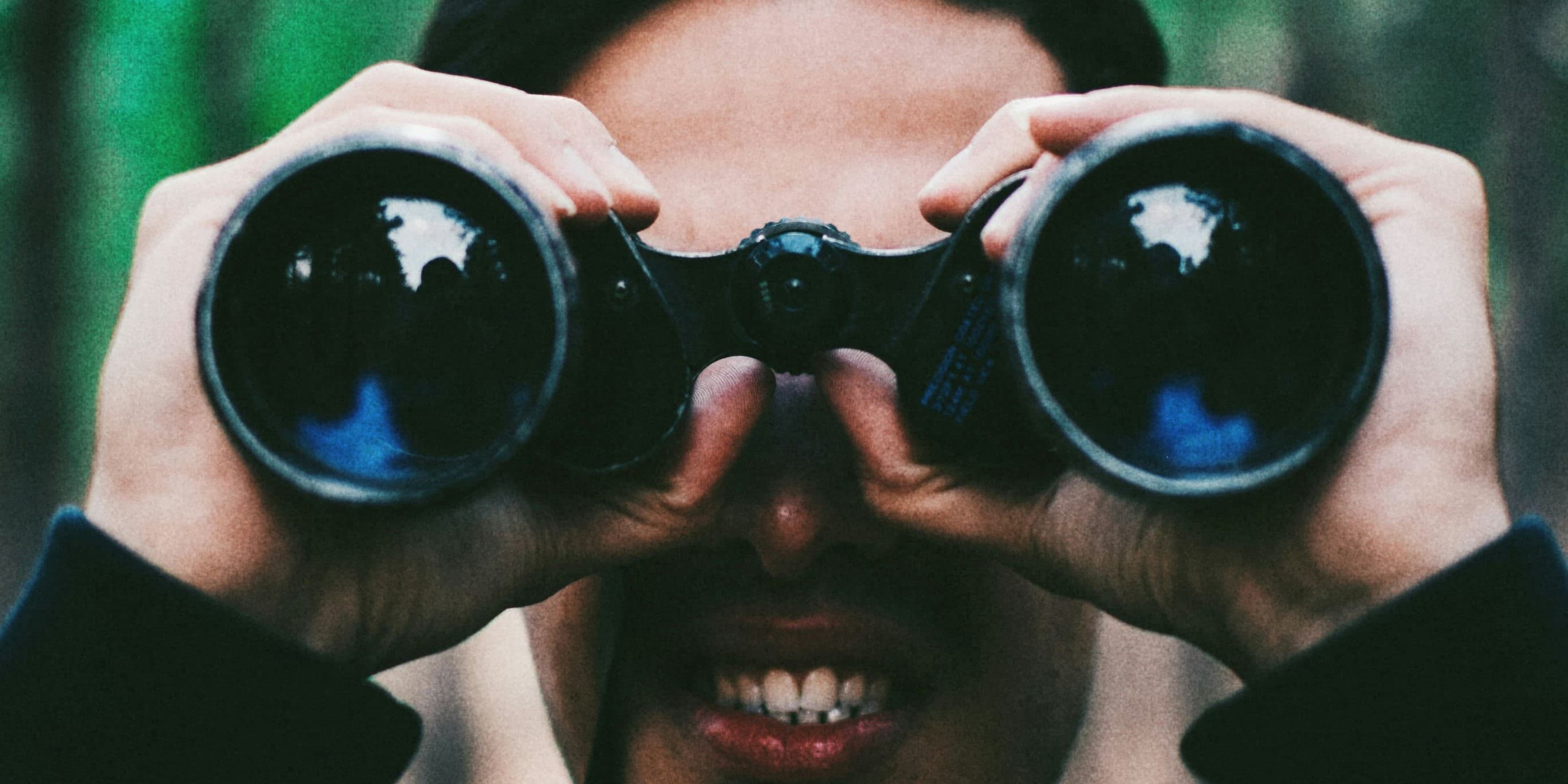 man looking through binoculars @shaianramesht on Unsplash