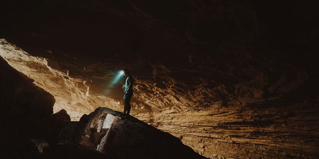 man in cave by @wandercreative on Unsplash